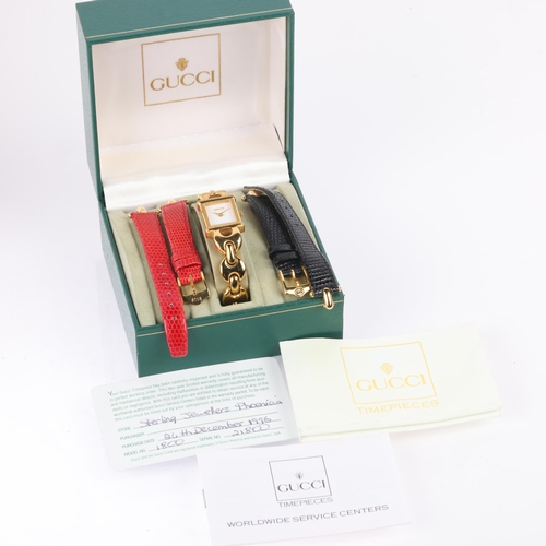 1030 - GUCCI - a lady's gold plated 1800L quartz bracelet watch, circa 1996, white dial with gilt lance han... 