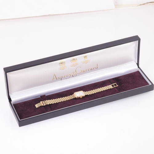 1031 - ASPREY & GARRARD - a lady's 9ct gold quartz bracelet watch, white dial with Roman numeral hour marke... 