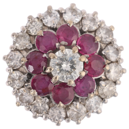 1113 - An 18ct gold ruby and diamond flowerhead cluster ring, claw set with round-cut rubies and modern rou... 