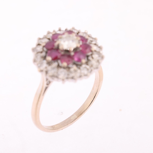 1113 - An 18ct gold ruby and diamond flowerhead cluster ring, claw set with round-cut rubies and modern rou... 