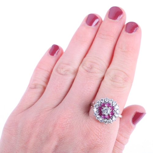 1113 - An 18ct gold ruby and diamond flowerhead cluster ring, claw set with round-cut rubies and modern rou... 