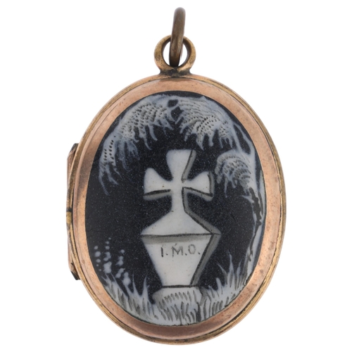 1122 - A Victorian monochrome enamel 'In Memory Of' mourning locket pendant, the front panel having hand pa... 