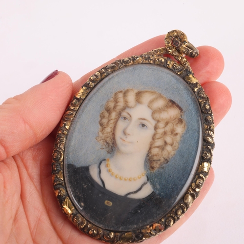 1124 - A large Georgian miniature portrait mourning pendant, circa 1800, the central miniature watercolour ... 