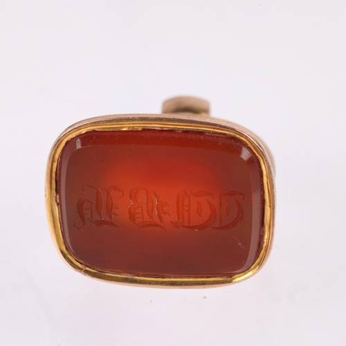 1144 - An Antique 9ct rose gold carnelian seal fob, the carnelian panel intaglio carved with initials WBH, ... 