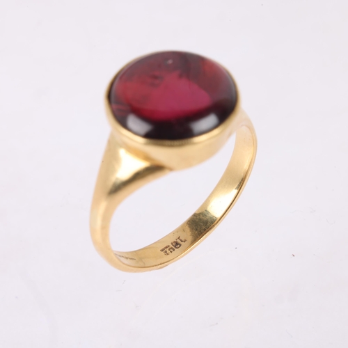 1145 - An 18ct gold single stone pink tourmaline ring, rub-over set with round cabochon tourmaline, setting... 