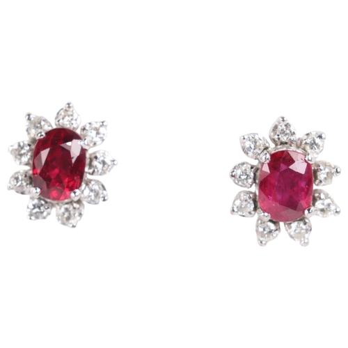 1148 - A pair of 18ct white gold ruby and diamond flowerhead cluster earrings, set with oval mixed-cut rubi... 