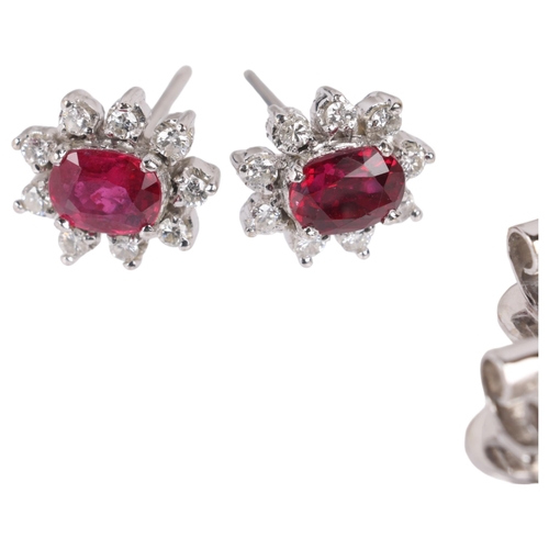 1148 - A pair of 18ct white gold ruby and diamond flowerhead cluster earrings, set with oval mixed-cut rubi... 