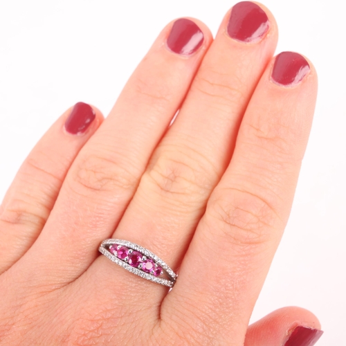 1149 - An 18ct white gold ruby and diamond ring, centrally claw set with 5 graduated round-cut rubies, flan... 