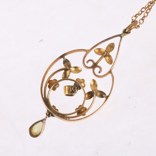 1150 - An Edwardian Art Nouveau 9ct gold peridot and split pearl openwork pendant necklace, on 15ct fine ca... 