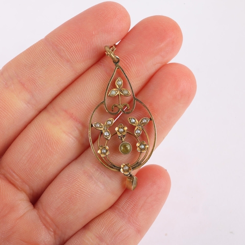 1150 - An Edwardian Art Nouveau 9ct gold peridot and split pearl openwork pendant necklace, on 15ct fine ca... 