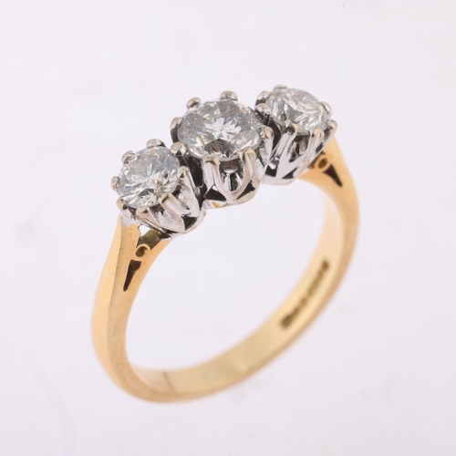 1152 - An 18ct gold three stone diamond ring, maker CMJ, London 1991, claw set with modern round brilliant-... 