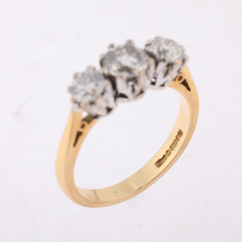 1152 - An 18ct gold three stone diamond ring, maker CMJ, London 1991, claw set with modern round brilliant-... 