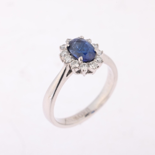 1157 - An 18ct white gold sapphire and diamond flowerhead cluster ring, by Browns, claw set with 1.15ct ova... 