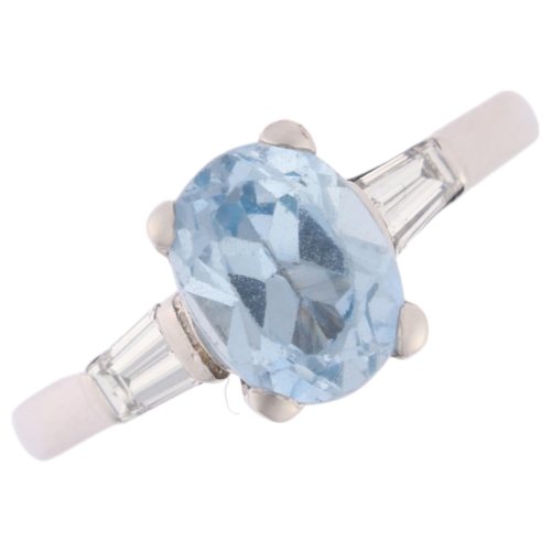 1161 - An 18ct white gold blue topaz and diamond ring, claw set with oval mixed-cut blue topaz, flanked by ... 