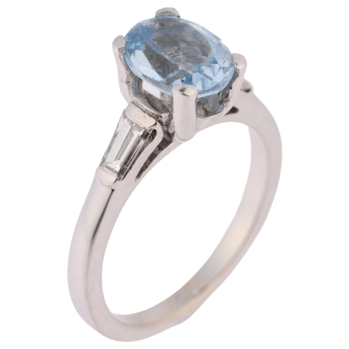 1161 - An 18ct white gold blue topaz and diamond ring, claw set with oval mixed-cut blue topaz, flanked by ... 