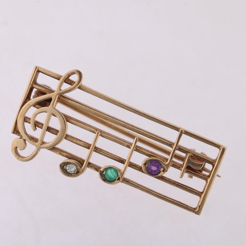 1166 - A Vintage 9ct gold gem set musical bar 'DEAR' brooch, maker RT, London 1991, set with diamond emeral... 