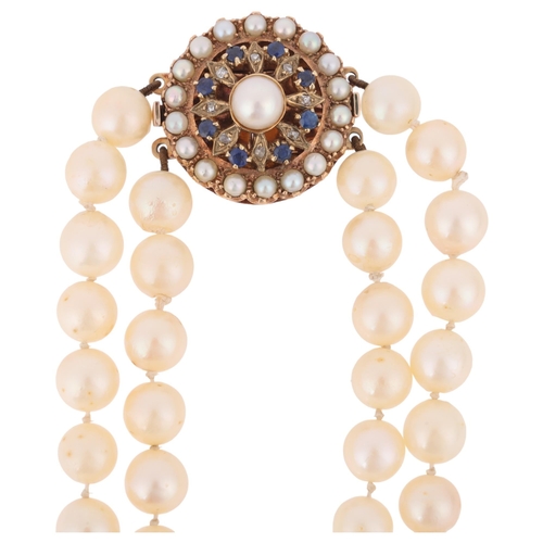 1177 - A Vintage 2-strand cultured pearl bead necklace, with unmarked gold sapphire and pearl flowerhead cl... 