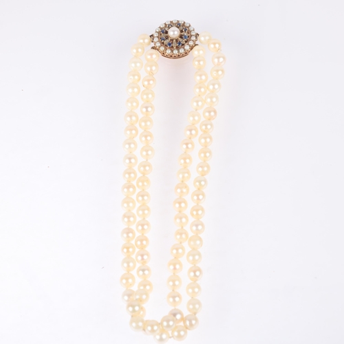 1177 - A Vintage 2-strand cultured pearl bead necklace, with unmarked gold sapphire and pearl flowerhead cl... 