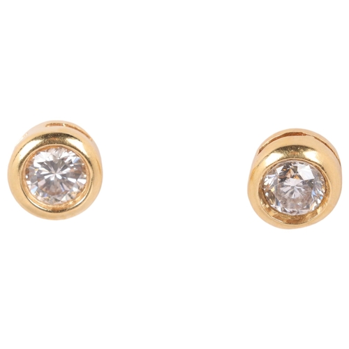 1183 - A pair of 18ct gold 0.6ct single stone diamond earrings, maker PH, each rub-over set with 0.3ct mode... 