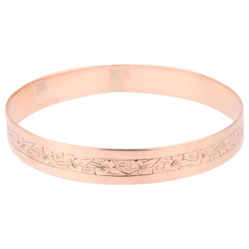 1189 - An Antique 9ct rose gold slave bangle, indistinct maker, floral engraved decoration, band width 11mm... 