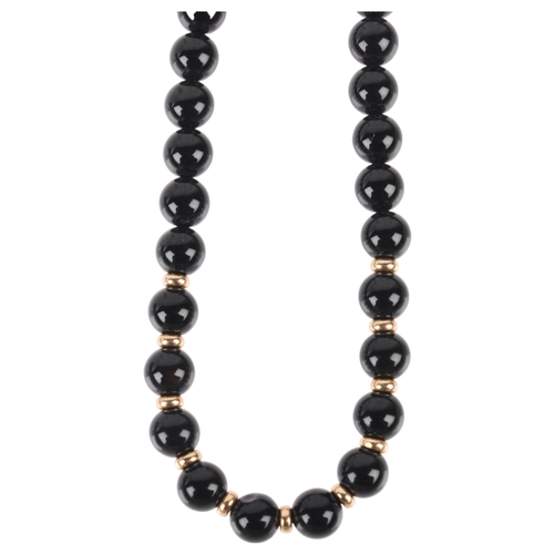 1203 - A 9ct gold onyx bead necklace, 6.1mm beads, 40cm, 19.5g