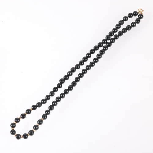 1203 - A 9ct gold onyx bead necklace, 6.1mm beads, 40cm, 19.5g