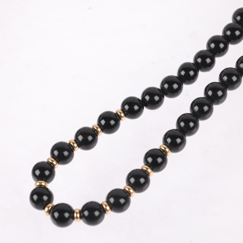 1203 - A 9ct gold onyx bead necklace, 6.1mm beads, 40cm, 19.5g