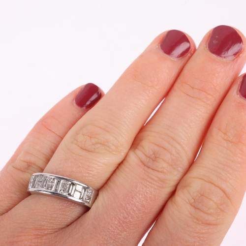 1204 - An 18ct white gold diamond half eternity ring, maker JSN, channel set with Princess and baguette-cut... 