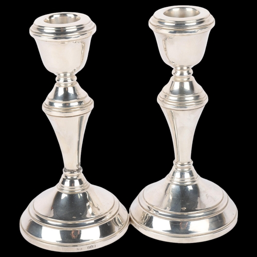 1694 - A pair of Elizabeth II silver table candlesticks, import London 1976, 14cm, loaded bases