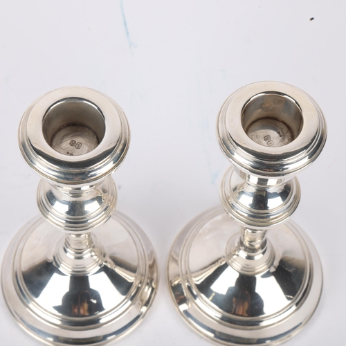 1694 - A pair of Elizabeth II silver table candlesticks, import London 1976, 14cm, loaded bases