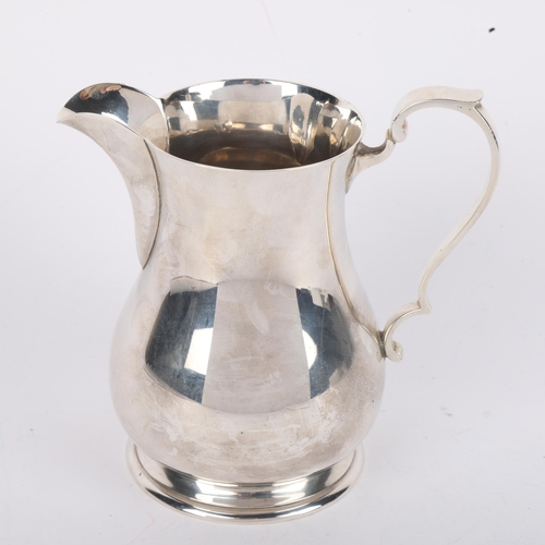 1699 - A George VI silver baluster cream jug, Harrison Brothers & Howson, Sheffield 1945, 10.5cm, 7oz