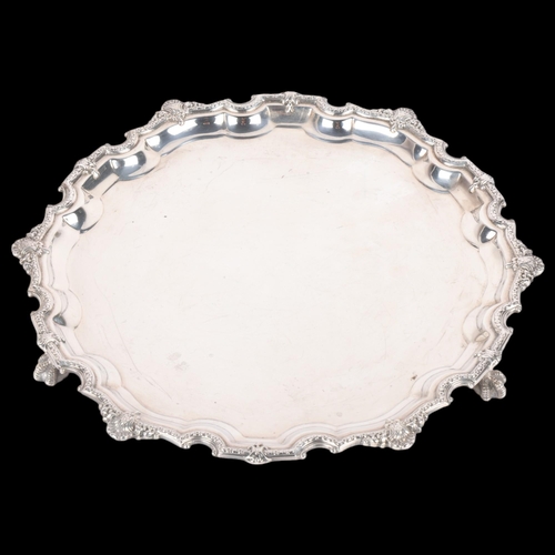 1703 - An Elizabeth II circular silver salver, Roberts & Dore Ltd, Sheffield 1968, cast scalloped rim, rais... 