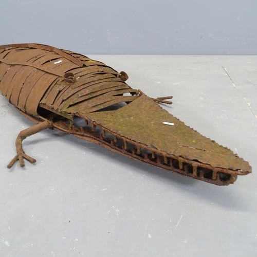 3004 - A weathered metal sculpture, study of a crocodile. Length overall 140cm.