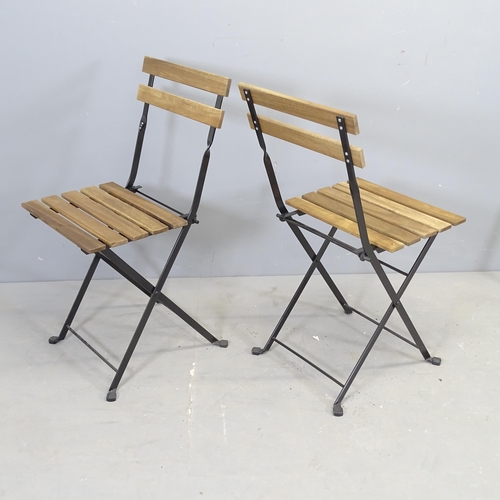 3007 - A Parisienne style folding bistro café table, 55x72cm, and four matching chairs.