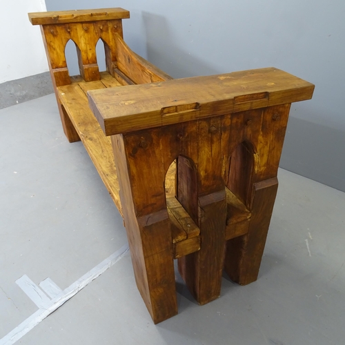 3024 - A stained pine gothic-style garden bench, by local Clive Fredriksson. 179x86x61cm.