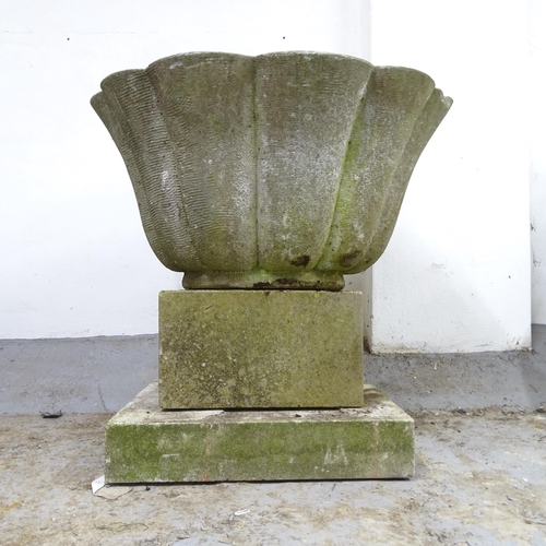 3025 - A large weathered stone scalloped oval three-section planter. 77x74x65cm.