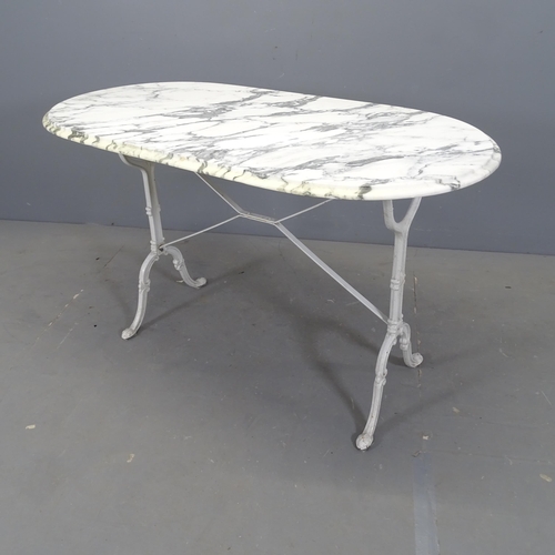 3034 - An oval marble-topped garden table on cast iron frame. 120x73x60cm.