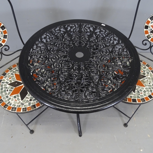 3042 - A painted aluminium circular garden table, 69x65cm, and two folding garden chairs with mosaic decora... 