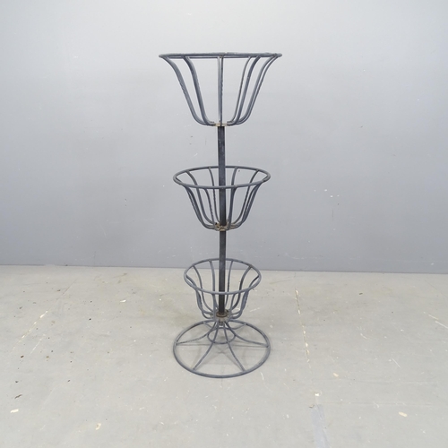 3046 - A painted wrought metal three-tier plant stand. 41x114cm.