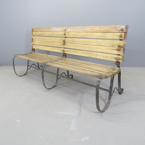 3051 - A folding slatted and iron framed garden bench. 180x82x52cm.