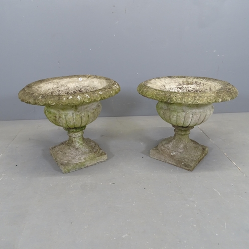 3055 - A pair of weathered concrete garden urns. 47x40cm.