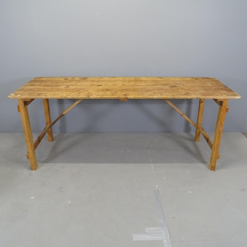 3066 - A vintage pine plank-top trestle table on folding base. 191x75x66cm.