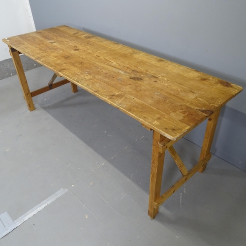 3066 - A vintage pine plank-top trestle table on folding base. 191x75x66cm.