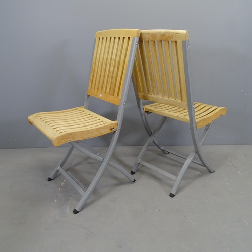 3068 - A set of four modern teak slatted folding garden chairs on metal frames.