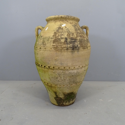 3069 - A large 2-hanfled terracotta oil jar. H - 67cm