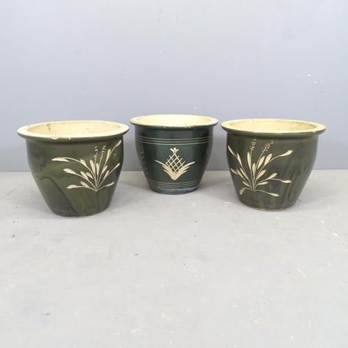 3072 - Three glazed terracotta garden pots. 39x31cm.