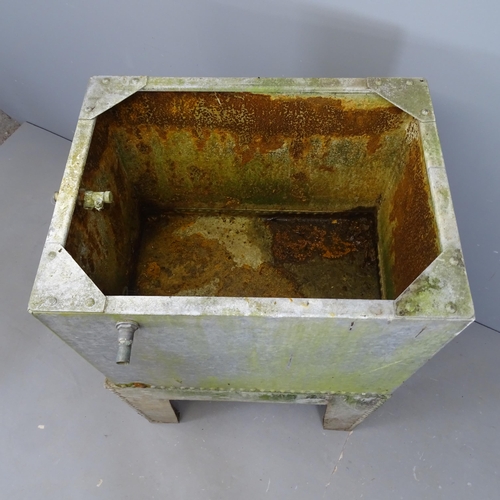 3073 - A galvanised metal water tank on stand. Overall (including tap) 90x116x57cm.