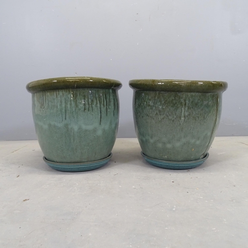 3092 - A pair of glazed terracotta garden pots, with drip trays. 37x32cm.