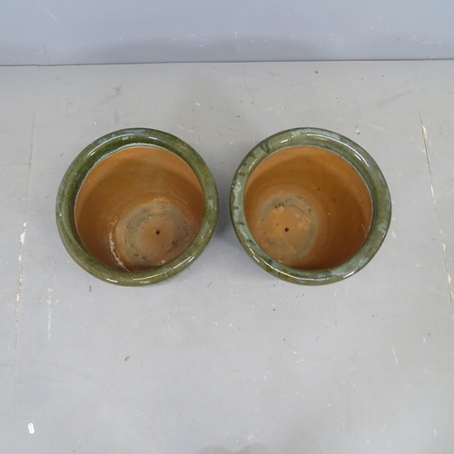 3092 - A pair of glazed terracotta garden pots, with drip trays. 37x32cm.