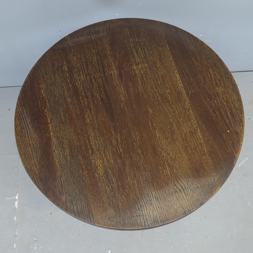 3101 - An oak circular-topped bistro table on painted cast iron base. 61x71cm.